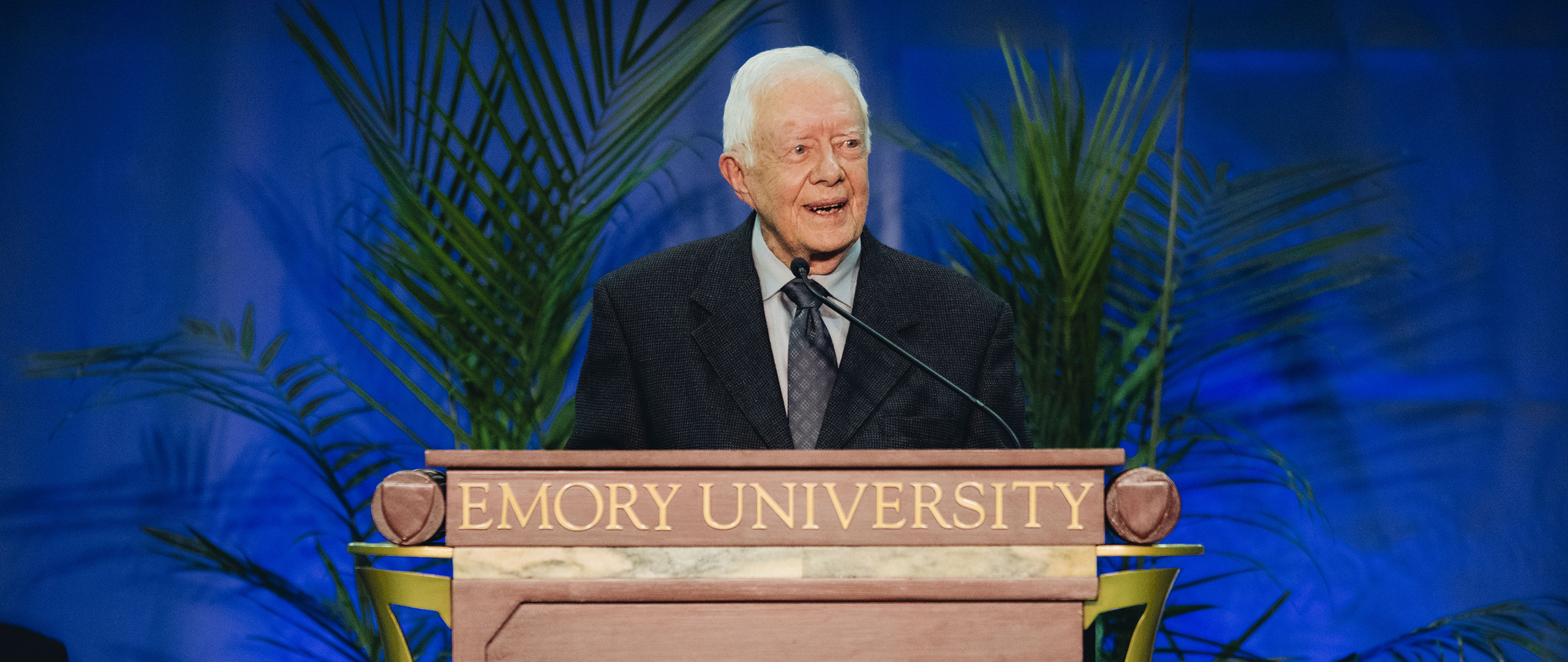 President Carter stands at at podium that says Emory University